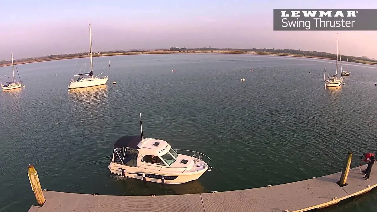 A still from Lewmar's Swing Thruster video: a small cabin cruiser coming alongside a pontoon, seen from above.